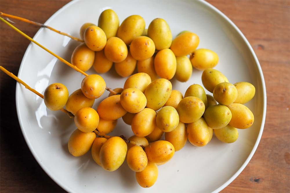 yellow barhi dates on a plate
